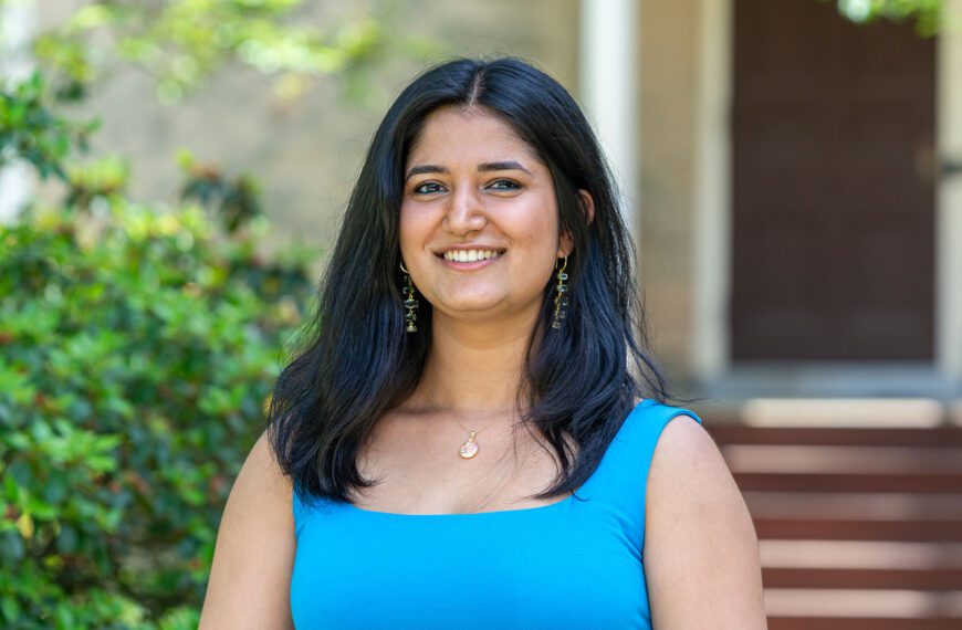 Bela Khanna wears a blue outfit and is pictured against one of Haverford's historic buildings.