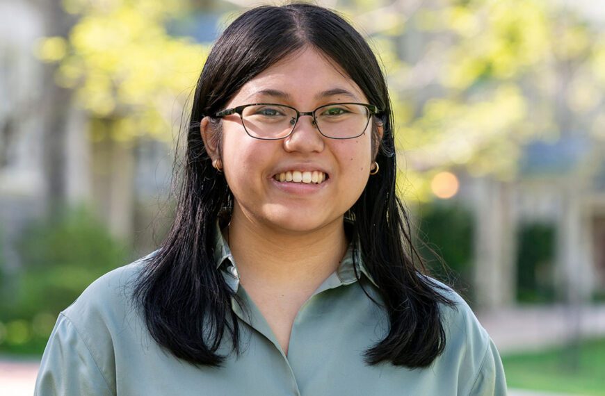 Maya Antonio is portrayed in a portrait taken on Haverford's campus. She wears glasses and a light green shirt.
