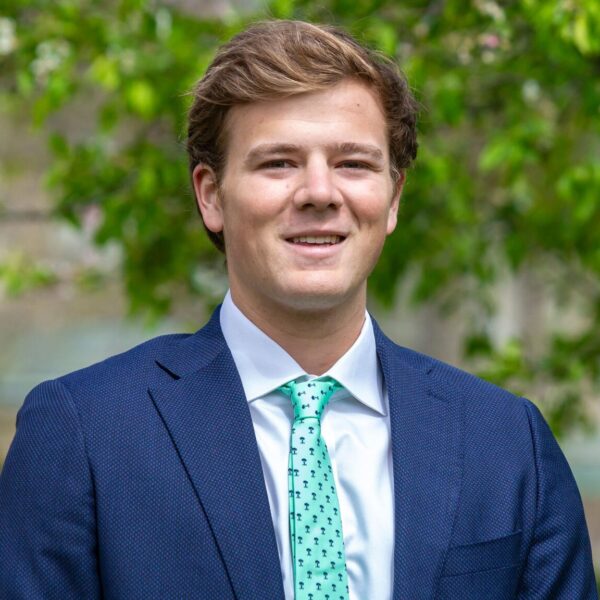 Clay Killoren is pictured in a portrait wearing a blue suit jacket and green tie.