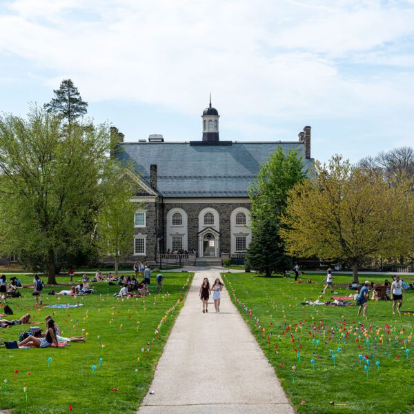 A wide view of campus shows students spread across the lawn for Pinwheel Day, with colorful pinwheels lining the walkways.